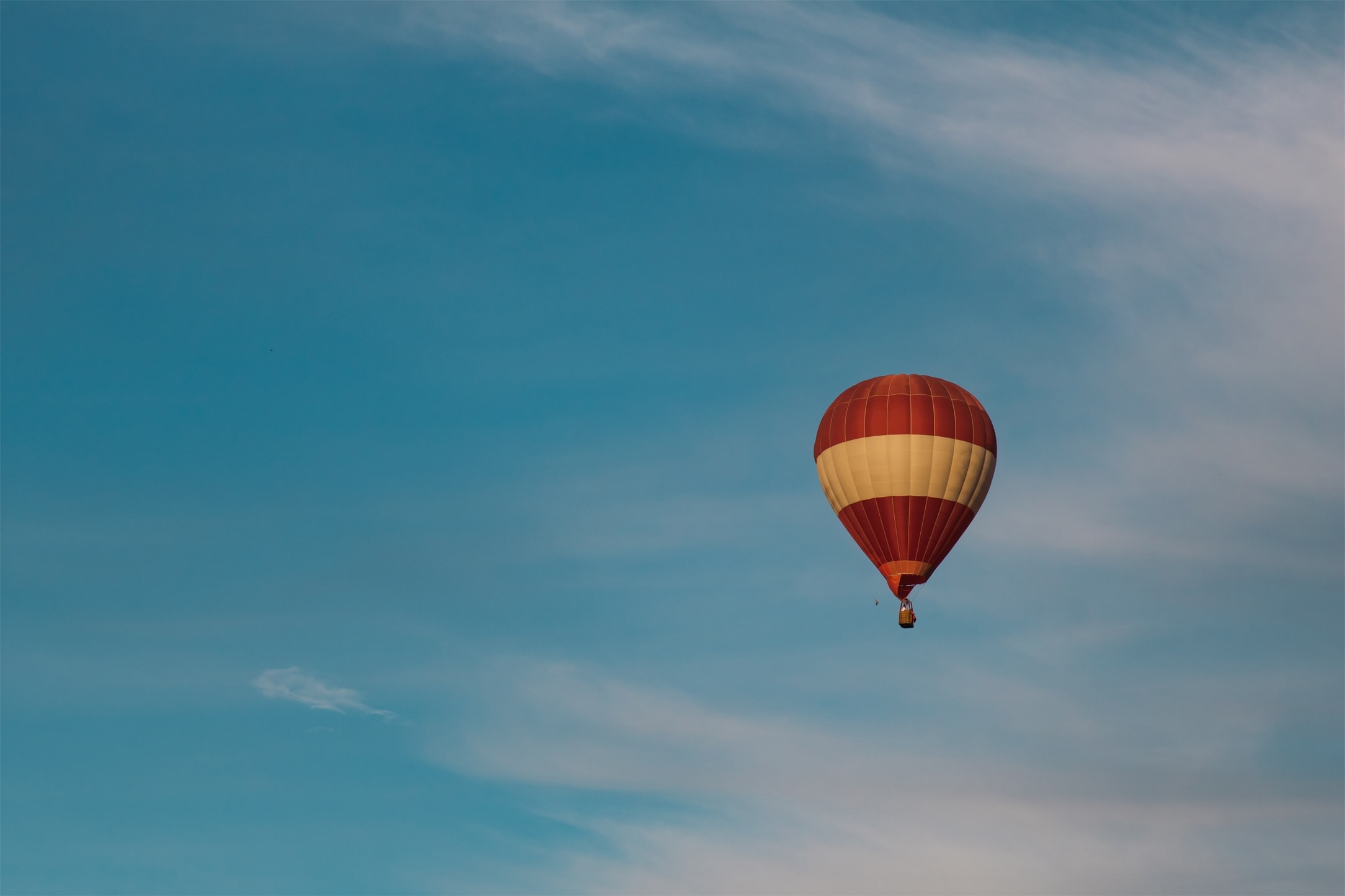 a picture of a hot air ballon soaring in the sky